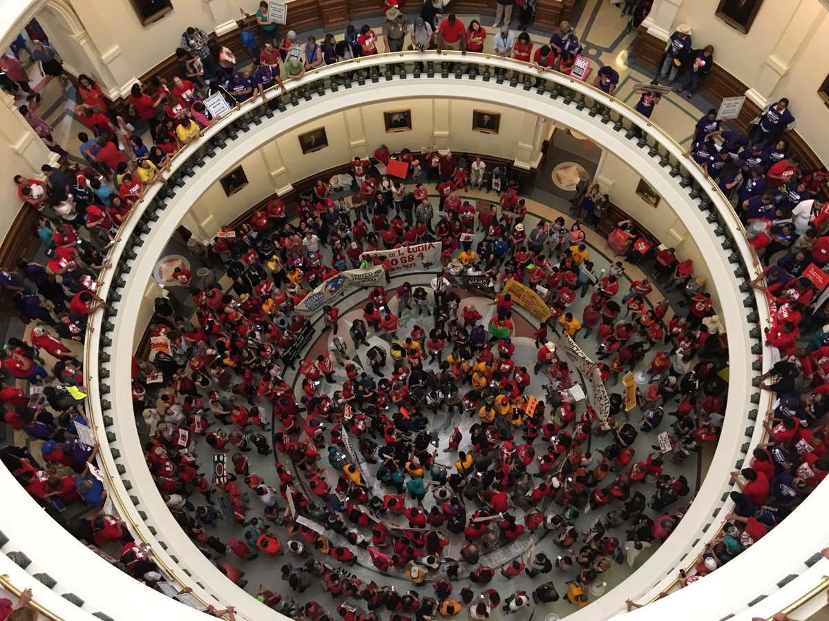 Photo of protesters at the Texas capitol rotunda.