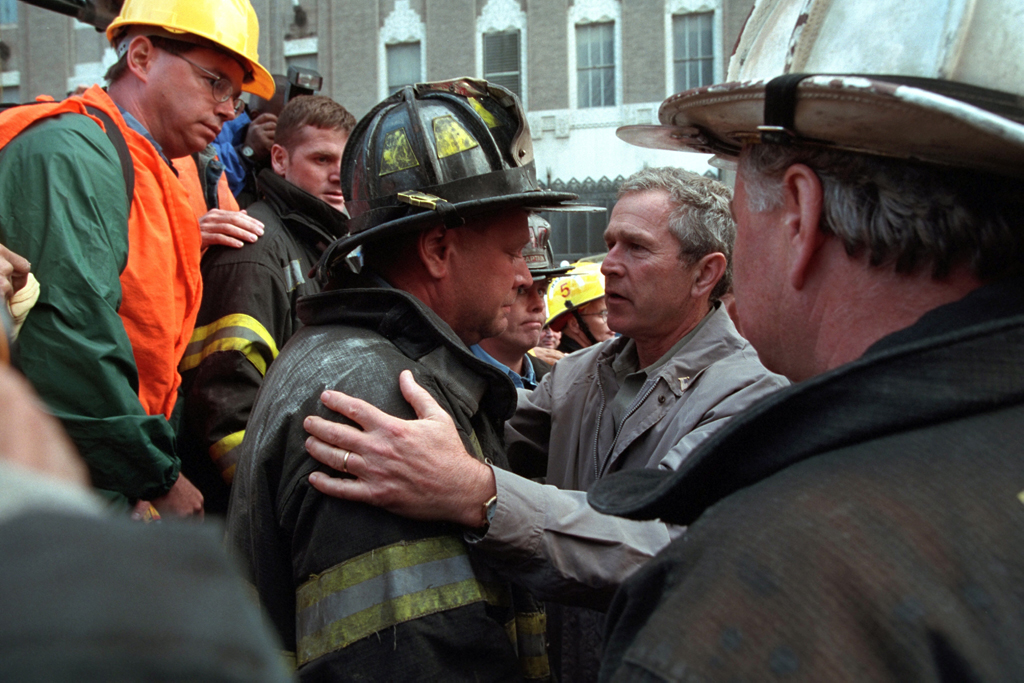 President George W. Bush embraces a firefighter at the site of the World Trade Center Friday, Sept. 14, 2001, during his visit to New York City. Photo by Paul Morse, Courtesy of the George W. Bush Presidential Library