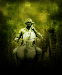 Photo of a statue: man sitting on bench, playing a cello.  The photo is soft focus and green-tinted
