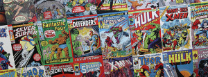 Photo of three rows of comic books laid side-by-side.  The photo is at an angle, so that the middle row is displayed clearly but top and bottom rows are cut off at either end.  Titles of comics include Silver Surfer, Fantastic Four, The Defenders, Amazing Spider-Man, The Incredible Hulk, and Giant-Size X-Men.