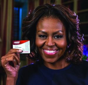 An image of Michelle Obama holding an AARP membership card.