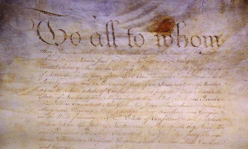 An image of an original handwritten version of the Articles of Confederation.