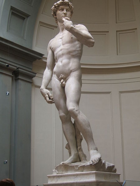 David stands nude in a contrapposto stance. His hand is brought up, and he is holding a sling.
