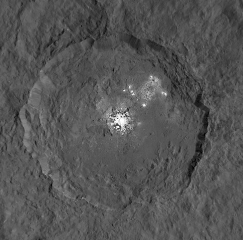 Occator Crater. In this view, looking directly down on Occator, bright features are seen on the floor of the crater at center and in the upper right.