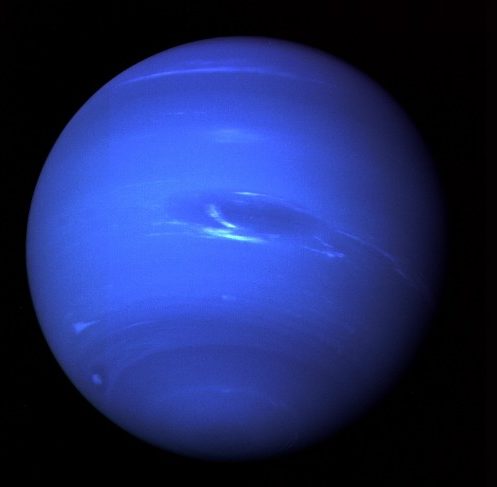 Blue Neptune. The blue sphere of Uranus is nearly featureless, save for dark bands near the poles, a few scattered white clouds, and a dark spot (near the center in this image) similar to the Great Red Spot on Jupiter.