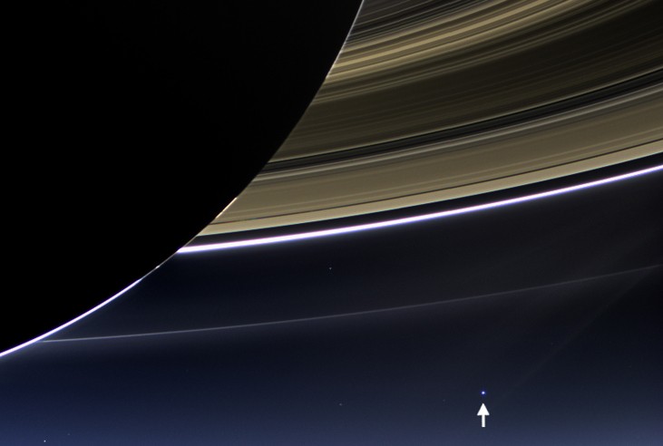 Image of the Earth from Saturn. The Earth appears in the distance as a pale blue dot (arrowed at lower right) below Saturn’s rings in this dramatic image from the Cassini orbiter. The night side of Saturn is seen at upper left, with the backlit rings covering the remaining top half of the image.