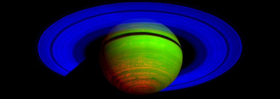 An image of Saturn seen in infrared. The rings are shown in blue, and the planet sphere is mostly green with some red at the bottom and a black ring around the upper top of the sphere.