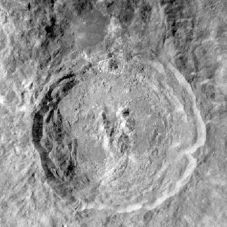 Photograph of King Crater on the Moon. This crater has the main features of a large impact: circular in shape, terraced walls, flat floor and central peaks.