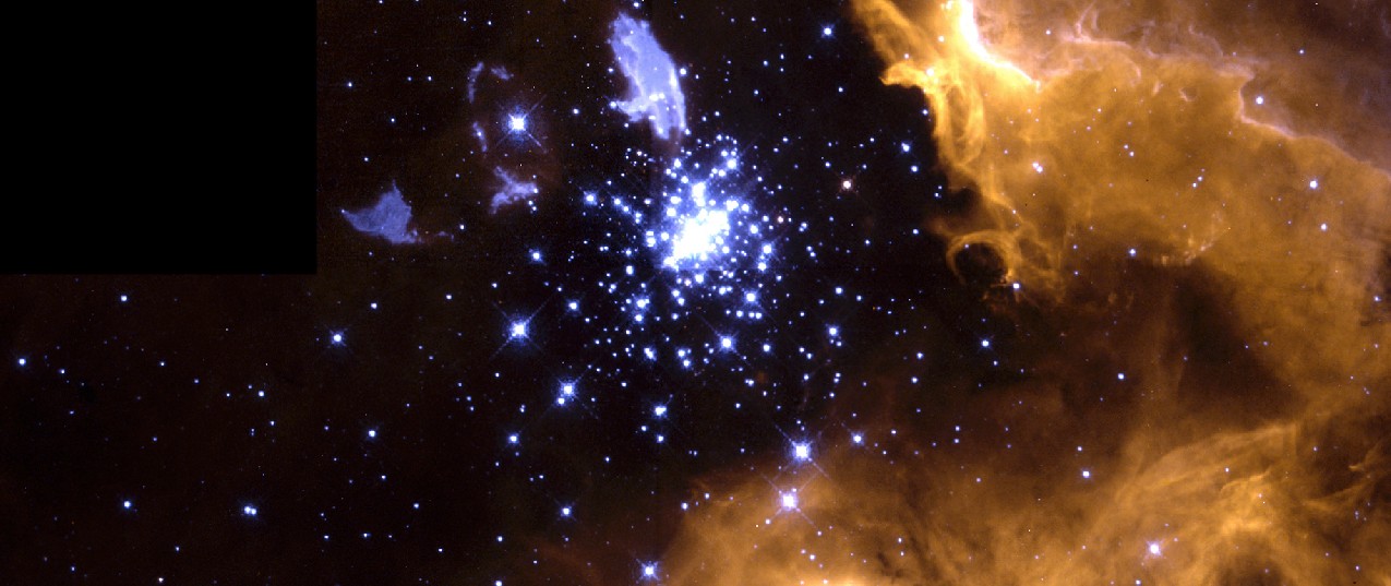 Image of NGC 3603 and Its Parent Cloud. The bright blue stars of the compact star cluster seen just above center in this image have blown a bubble in the gas cloud from which they formed. Part of this reddish cloud is seen in the right hand side and lower center of the frame. Irregular blue clouds and streaks are seen above and to the left of the star cluster.