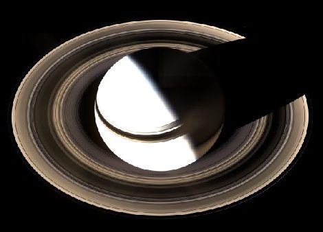 Image of Saturn and its Rings. Taken almost directly over one of Saturn’s poles, the rings are seen nearly face-on, completely encircling the planet. Sunlight arrives from lower left as the rings cast a thin shadow on Saturn’s cloud tops, while Saturn itself casts a shadow on the rings at upper right.