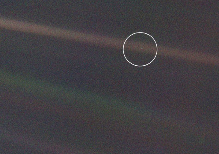 Earth from 4 billion miles. The Earth (circled) appears as a mere speck of light in this Voyager image. No signs of life, or any surface features at all, are evident.