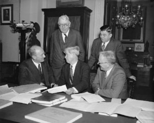 A photo of Henry Morgenthau, Jr., Daniel Bell, and three members of the House Appropriations Committee.