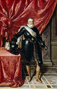 Portrait of Henry the IV of France. He is dressed in all black standing in front of a red curtain.