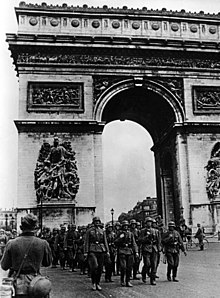 Image of German soldiers marching past the Arc de Triomphe. 