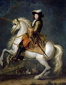 Louis XIV of France riding a white horse that is rearing up in the air. 