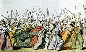 An illustration of the women's march on Versailles. A crowd of women are gathered holding spears and pulling handcarts.