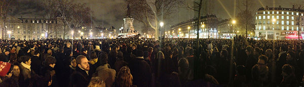 Crowds of people gathered at night to pledge solidarity to liberal French values after the Charlie Hebdo shooting.