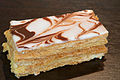 A French pastry called Mille-feuille that has layers of pastry topped with chocolate and vanilla swirled icing. 