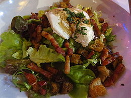 Salade lyonnaise on a plate. 