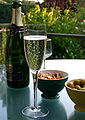 A glass filled with champagne on a table outside. 