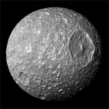 Image of Saturn’s satellite Mimas, a gap moon with a moon-splitting crater, looking like the Death Star.