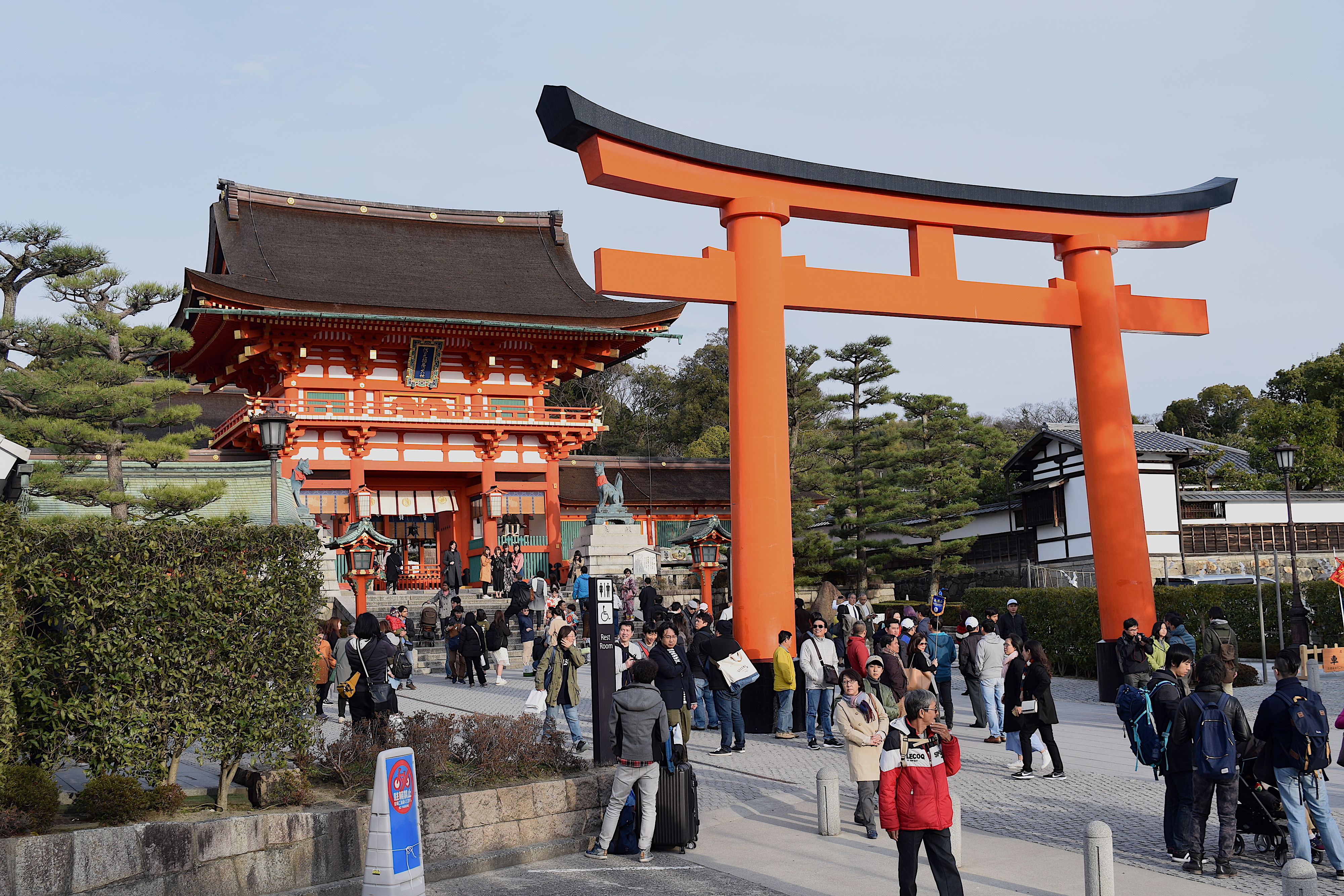 The Fushimi Inari Shrine is the largest shrine. It is famous for the large number of red gates (torii) at the site. Further described in text.
