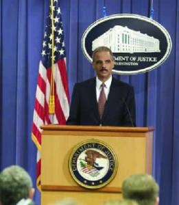 A photo of Eric Holder holding a press conference.