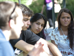Photo of group of college students in a conversation group outside