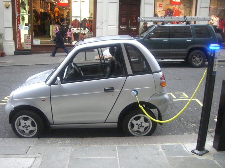 Photo of car plugged into a charging station.