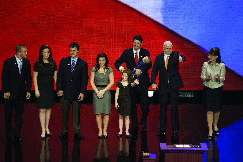 An image of Sarah Palin on a stage with John McCain and several other people.