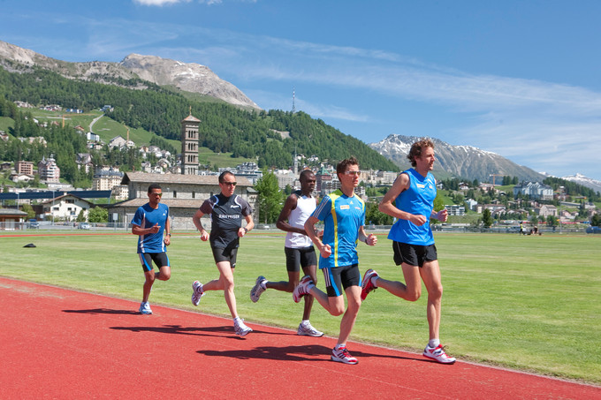 This is a color photo of athletes running at an athletic training camp in the Swiss Alps.