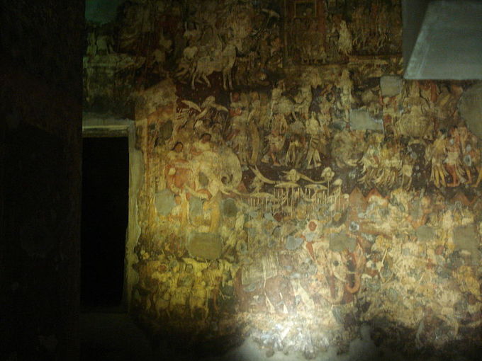 This photo shows an example of a fresco painting. The fragments of murals and paintings in the caves depict the past lives and rebirths of the Buddha.