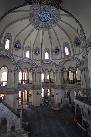 This is a current-day photo of Little Hagia Sophia. It captures the dome decorated with a blue floral stained glass pattern.