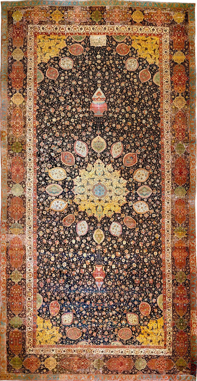 This photo shows the Ardabil Carpet from Persia. Rug with an intricate floral pattern and central medallion.