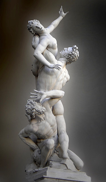 Sculpture consists of three figures: a man lifting a woman into the air while a second man crouches.