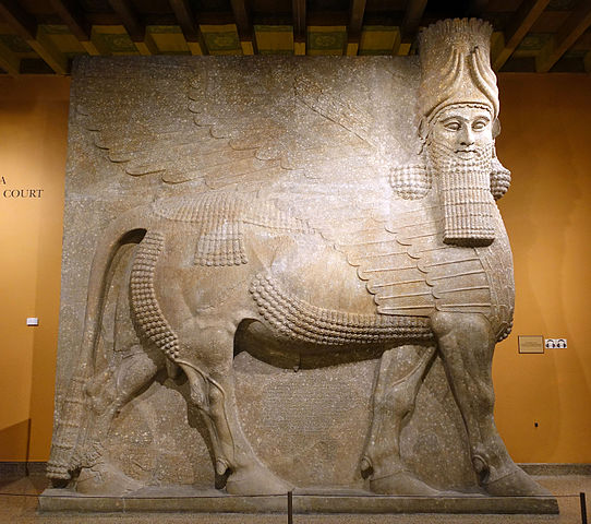Large sculpture of an Assyrian protective deity with a human head and the body of an ox.