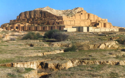 Photograph of Chogha Zanbil ziggarut, a terraced step pyramid receding levels made from baked mud brick.