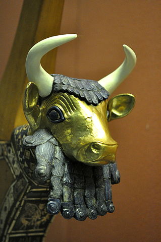 Photograph of a lyre (musical instrument similar to a harp). The head of the lyre is a sculpture of a bull head.
