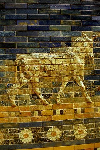 Photo depicts a close-up of the bull figure on the Gate of Ishtar, constructed with glazed gold brick.
