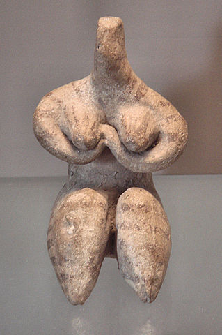 Statue depicts a nude woman with round breasts and plump thighs. The statue has no head.