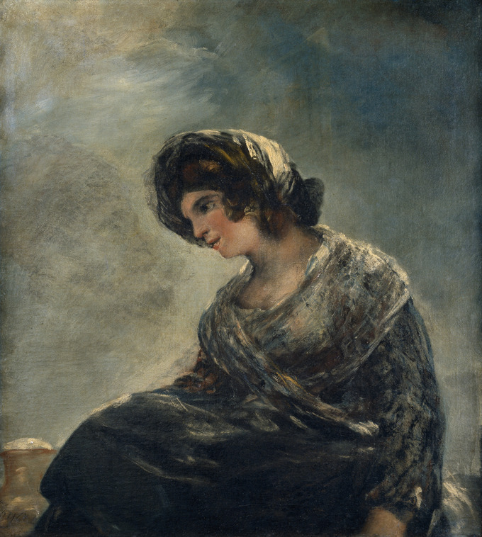 Painting depicts a woman dressed in dark clothing and a head scarf sitting and gazing downwards.