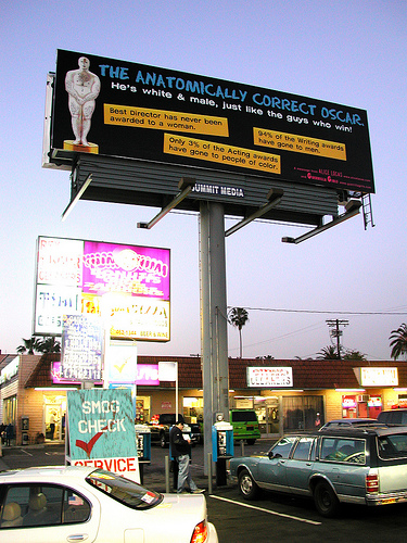 A photo of a billboard describing the “anatomically correct Oscar” and pointing out facts about inequality at the Oscars.