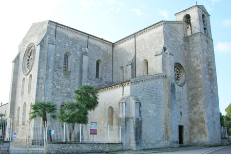 Image of outside of Abbey church of Santa Maria Arabona, Italy. A large, stone building with very little decoration.