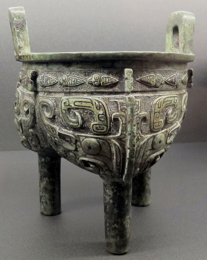 This three-legged vessel is intricately decorated.