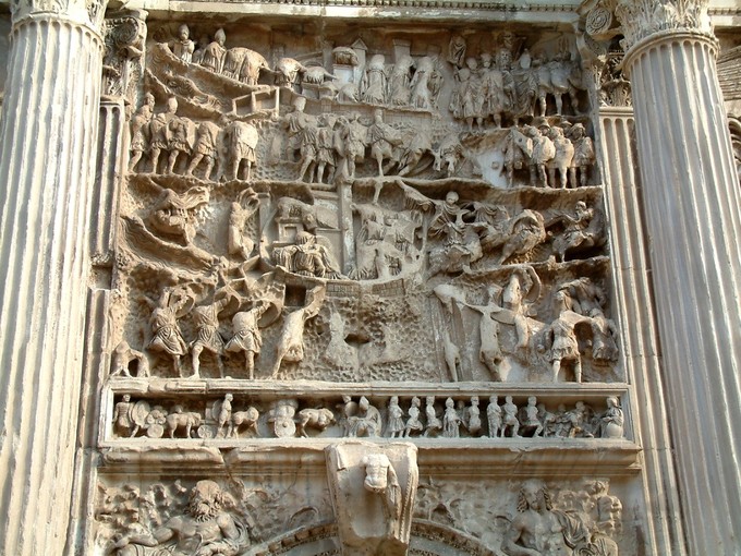 Photograph shows a panel relief between two flutes columns.