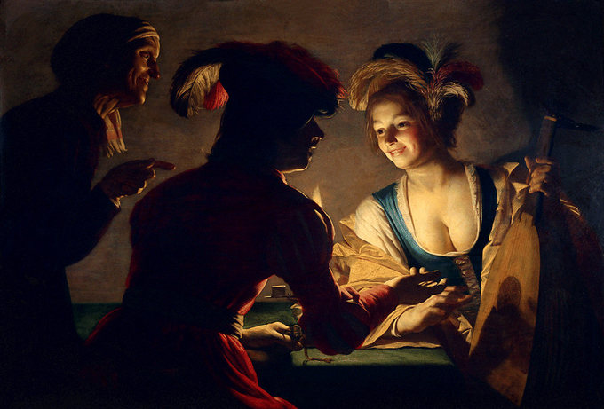 Scene depicts a woman lit by a single candle, leaning on a table, smiling. Two men in shadows are conversing with her.