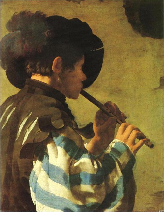 A man is shown playing a flute. He is seen from the side, looking away from the viewer.