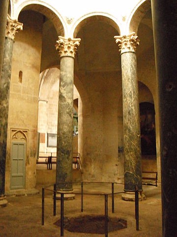 The interior of the Baptistery with two columns and a hole in the floor.