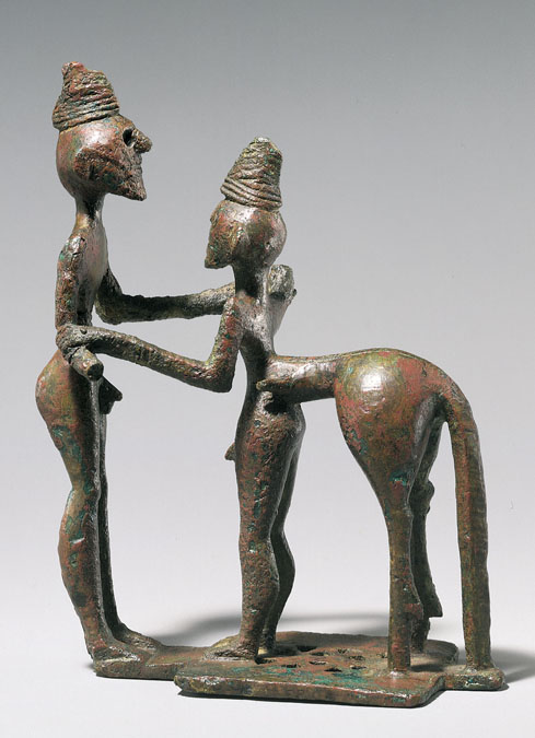 This is a photo of the small bronze statue Man and Centaur (Heracles and Nessos). The two figures feature elongated arms, with the right arm of the centaur forming one continuous line with the left arm of the man.