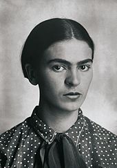 This is a black and white photo portrait of Frida Kahlo.
